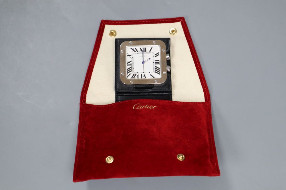 A Cartier stainless steel travelling alarm timepiece, with original fabric pouch